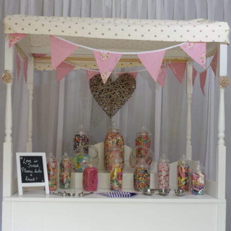 Image showing sweet jars on a wooden cart